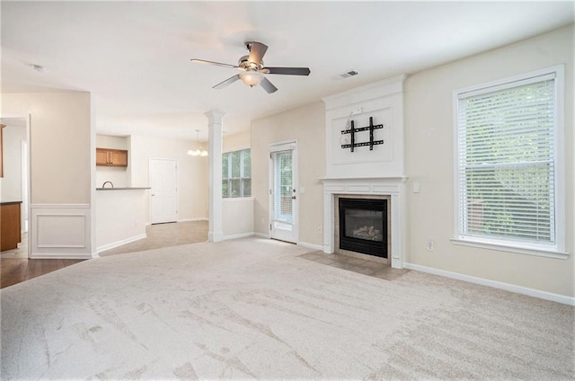 157 Spur Ln, Hiram, GA 30141 - unfurnished living room featuring ceiling fan, plenty of natural light, a fireplace with flush hearth, and light colored carpet