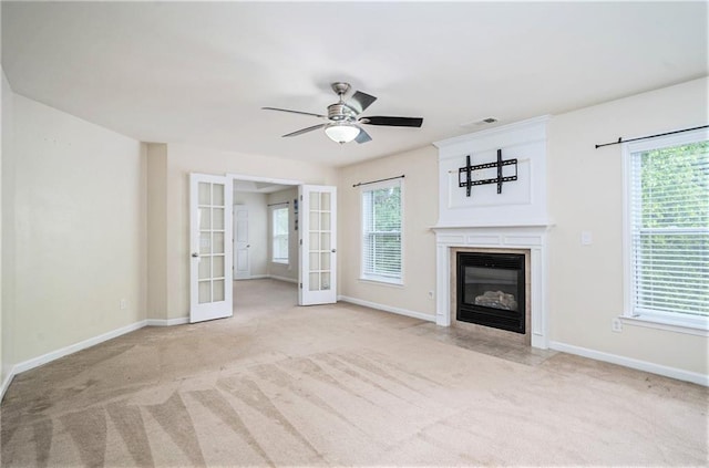 157 Spur Ln, Hiram, GA 30141 - unfurnished living room with french doors, a glass covered fireplace, a ceiling fan, and carpet flooring