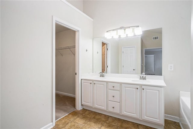 157 Spur Ln, Hiram, GA 30141 - bathroom with double vanity, a tub to relax in, and baseboards