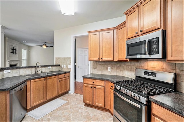 157 Spur Ln, Hiram, GA 30141 - kitchen featuring stainless steel appliances, a sink, ceiling fan, and dark countertops
