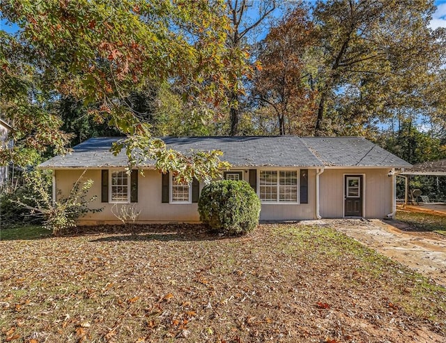 ranch-style home featuring a carport