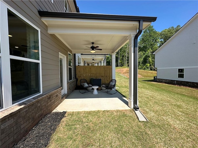 view of patio featuring ceiling fan and fence