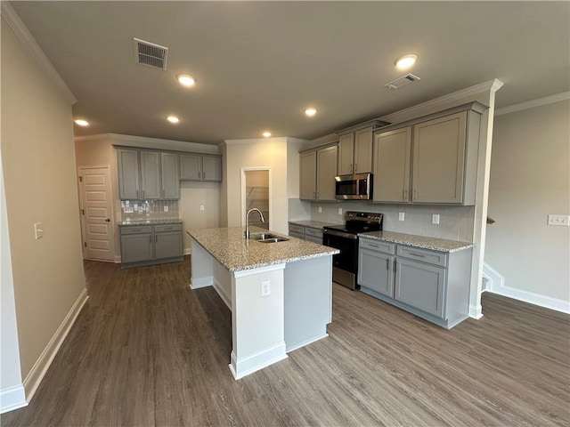 kitchen featuring gray cabinets, visible vents, crown molding, appliances with stainless steel finishes, and a sink