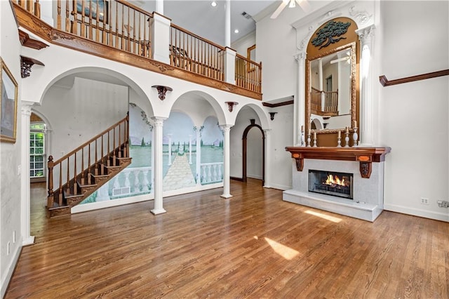 11569 Finley St, Suwanee, GA 30024 - entrance foyer with a towering ceiling, a glass covered fireplace, ceiling fan, wood finished floors, and stairway