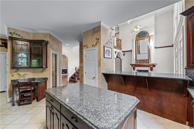 11569 Finley St, Suwanee, GA 30024 - kitchen with a ceiling fan, light tile patterned flooring, and dark stone countertops