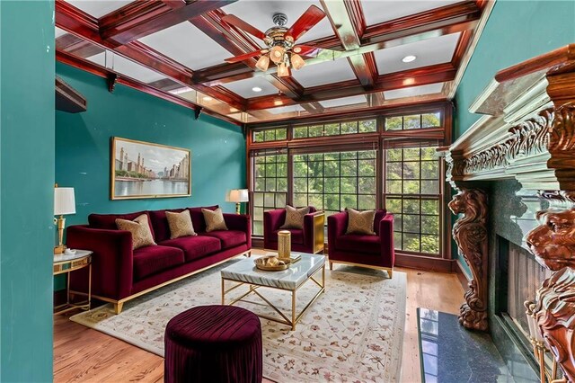 11569 Finley St, Suwanee, GA 30024 - living area featuring a premium fireplace, ceiling fan, wood finished floors, beam ceiling, and coffered ceiling