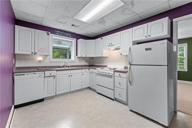 11569 Finley St, Suwanee, GA 30024 - kitchen with white appliances, a sink, a drop ceiling, white cabinetry, and decorative backsplash