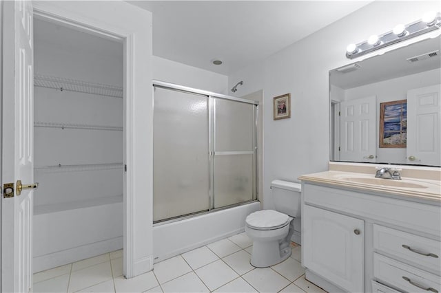11569 Finley St, Suwanee, GA 30024 - full bathroom with toilet, vanity, tile patterned floors, and combined bath / shower with glass door
