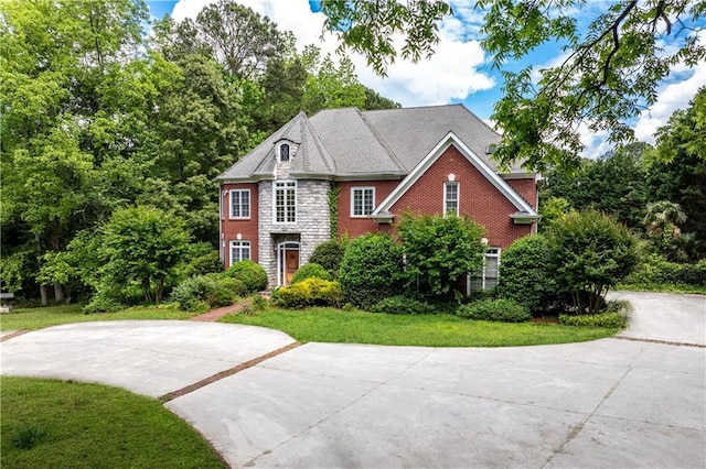 11569 Finley St, Suwanee, GA 30024 - view of front of property featuring driveway, a front lawn, and brick siding