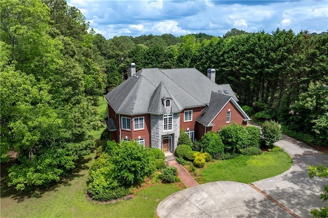 11569 Finley St, Suwanee, GA 30024 - view of front of property with a chimney, stone siding, and a wooded view