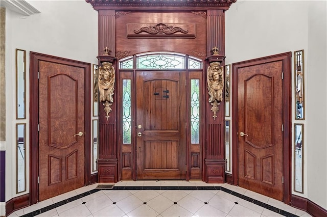 11569 Finley St, Suwanee, GA 30024 - tiled entryway featuring inlaid floor details, baseboards, and a high ceiling