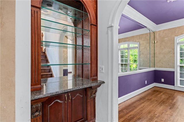 11569 Finley St, Suwanee, GA 30024 - bar featuring ornamental molding, healthy amount of natural light, wood finished floors, baseboards, and stairway