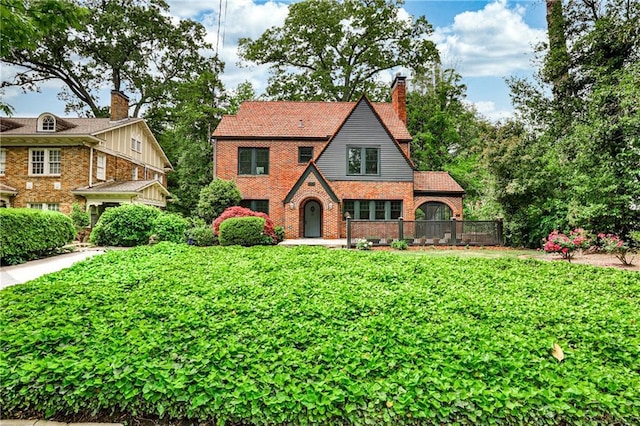 50 Rumson Way NE, Atlanta, GA 30305 - tudor-style house featuring brick siding and a chimney