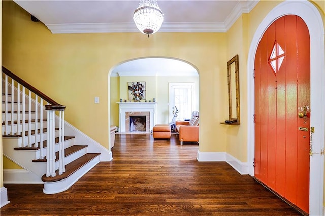 50 Rumson Way NE, Atlanta, GA 30305 - foyer with crown molding, arched walkways, wood finished floors, and a tiled fireplace