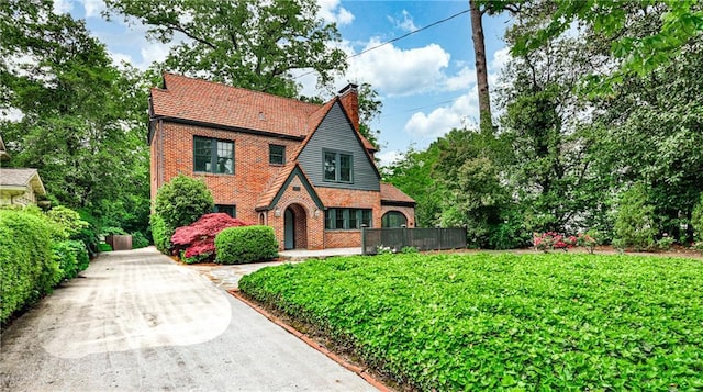 50 Rumson Way NE, Atlanta, GA 30305 - tudor home featuring brick siding and a chimney