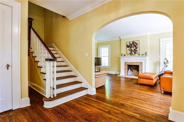 50 Rumson Way NE, Atlanta, GA 30305 - stairs with arched walkways, a tiled fireplace, baseboards, wood finished floors, and ornamental molding