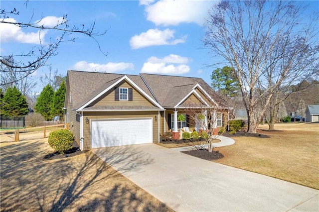 view of front of house featuring an attached garage, concrete driveway, a front lawn, and fence