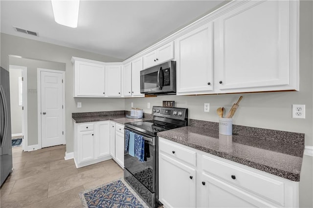 kitchen featuring visible vents, white cabinets, appliances with stainless steel finishes, and dark stone countertops