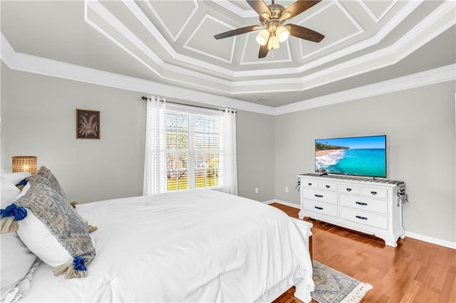 bedroom featuring baseboards, a ceiling fan, wood finished floors, and crown molding