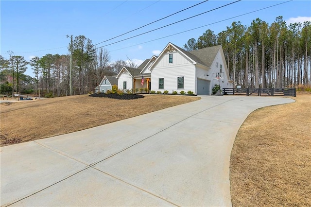 view of front of home featuring a front yard, board and batten siding, concrete driveway, and an attached garage