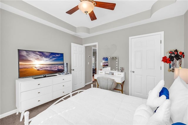 bedroom with a ceiling fan, baseboards, and carpet floors