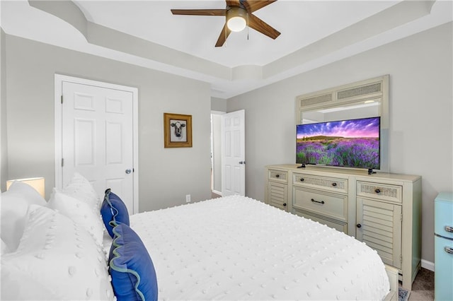 bedroom featuring a tray ceiling and ceiling fan