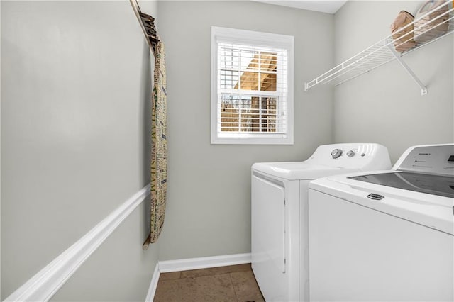 laundry room with washer and dryer, laundry area, baseboards, and tile patterned floors