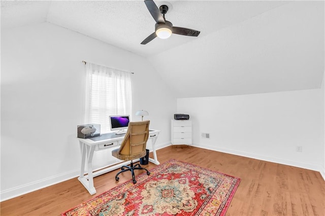 office featuring baseboards, wood finished floors, and vaulted ceiling