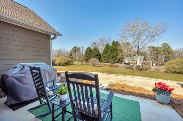 view of patio / terrace with fence and a grill