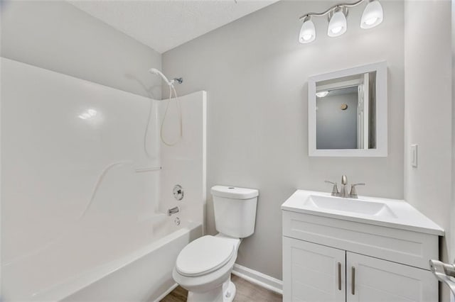 full bathroom with vanity, shower / tub combination, and toilet