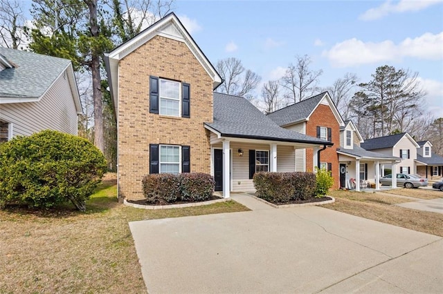 view of front property with a porch and a front lawn