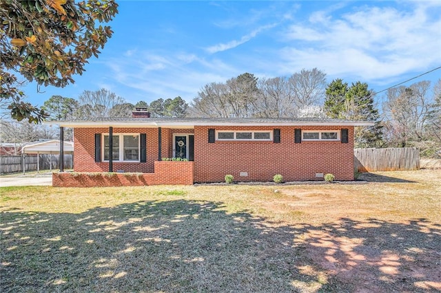 single story home with brick siding, a chimney, fence, a carport, and a front lawn