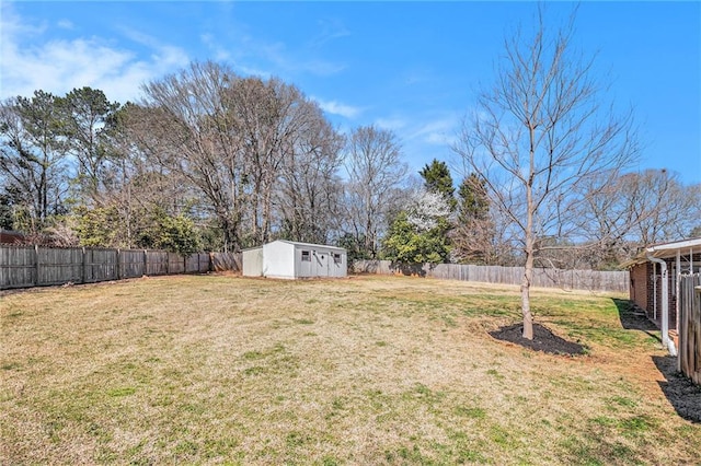 view of yard featuring a fenced backyard, an outdoor structure, and a shed