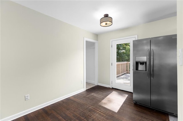 interior space featuring dark wood-style flooring and baseboards