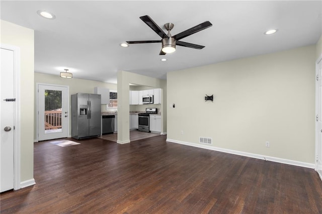 unfurnished living room featuring baseboards, visible vents, a ceiling fan, dark wood-type flooring, and recessed lighting