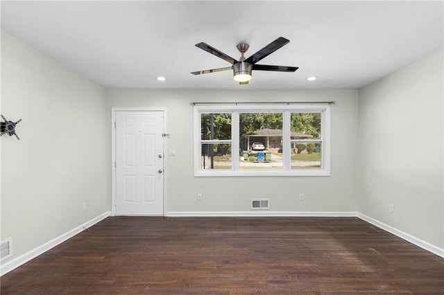 empty room with baseboards, visible vents, dark wood finished floors, and recessed lighting