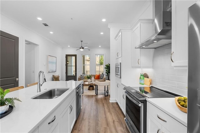 4918 Sudbrook Way Unit 252, Peachtree Corners, GA 30092 - kitchen with stainless steel appliances, light countertops, a sink, and wall chimney range hood