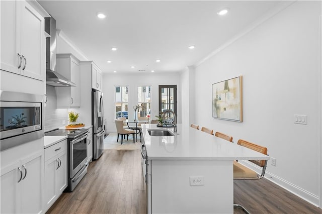 4918 Sudbrook Way Unit 252, Peachtree Corners, GA 30092 - kitchen featuring wall chimney exhaust hood, a sink, appliances with stainless steel finishes, and dark wood-style flooring
