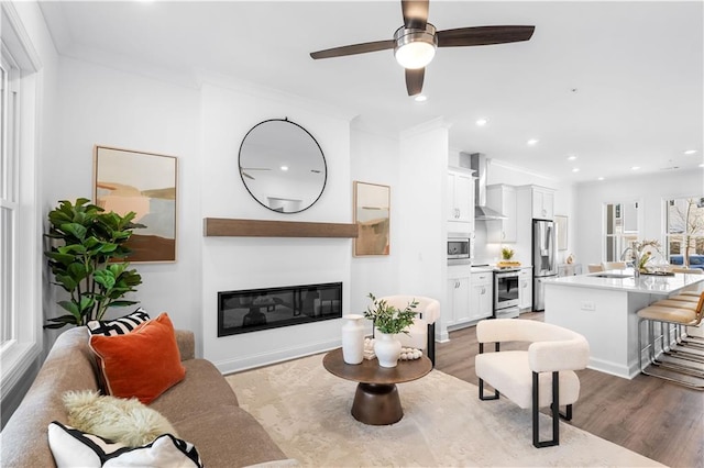 4918 Sudbrook Way Unit 252, Peachtree Corners, GA 30092 - living room featuring a glass covered fireplace, recessed lighting, a ceiling fan, wood finished floors, and crown molding