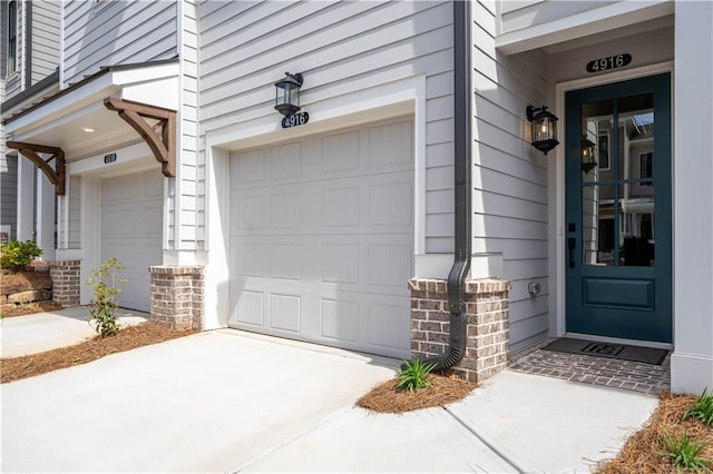 4918 Sudbrook Way Unit 252, Peachtree Corners, GA 30092 - doorway to property featuring an attached garage, stone siding, and concrete driveway