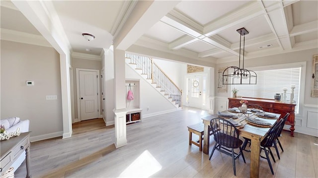 dining room with coffered ceiling, beam ceiling, light hardwood / wood-style flooring, and a wealth of natural light