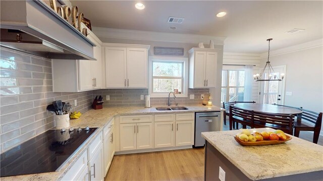 kitchen featuring tasteful backsplash, visible vents, a sink, light wood-type flooring, and dishwasher