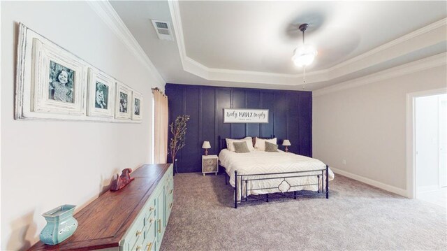 carpeted bedroom with baseboards, a raised ceiling, visible vents, and crown molding