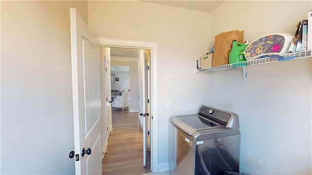 laundry room featuring washer / dryer and light hardwood / wood-style floors