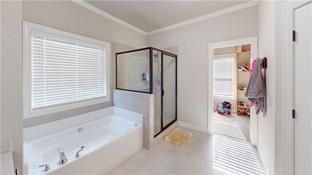 full bath with a shower stall, baseboards, a garden tub, and crown molding