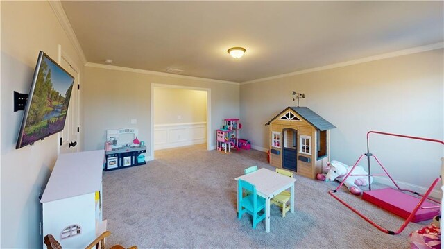 rec room with carpet floors and ornamental molding