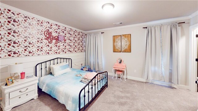 carpeted bedroom with ornamental molding and visible vents