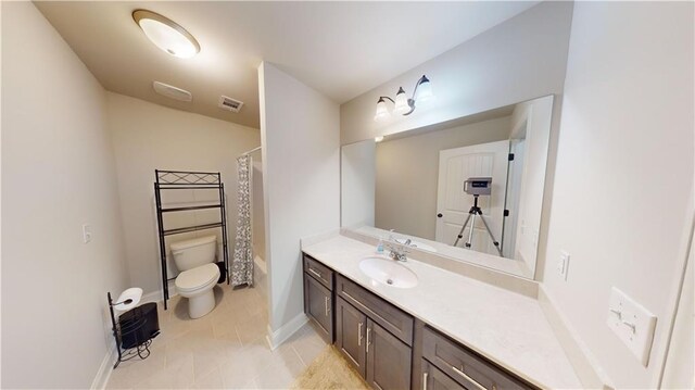 bathroom with visible vents, baseboards, toilet, tile patterned floors, and vanity