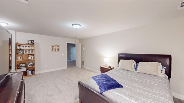 carpeted bedroom with visible vents and baseboards