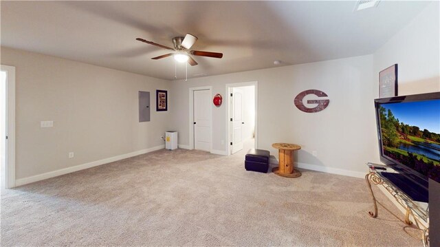 unfurnished living room with baseboards, carpet floors, electric panel, and a ceiling fan